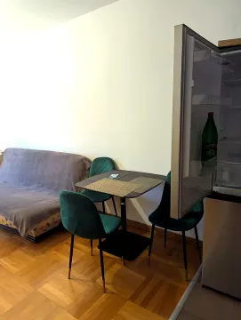 Living room with a sofa, dining table, and chairs. - image 3