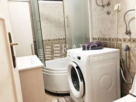 Smaller bathroom with a shower cabin and a washing machine. - image 7