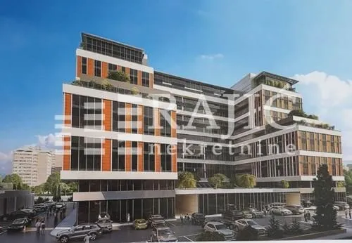 Exterior view of a modern residential and commercial building with parking.