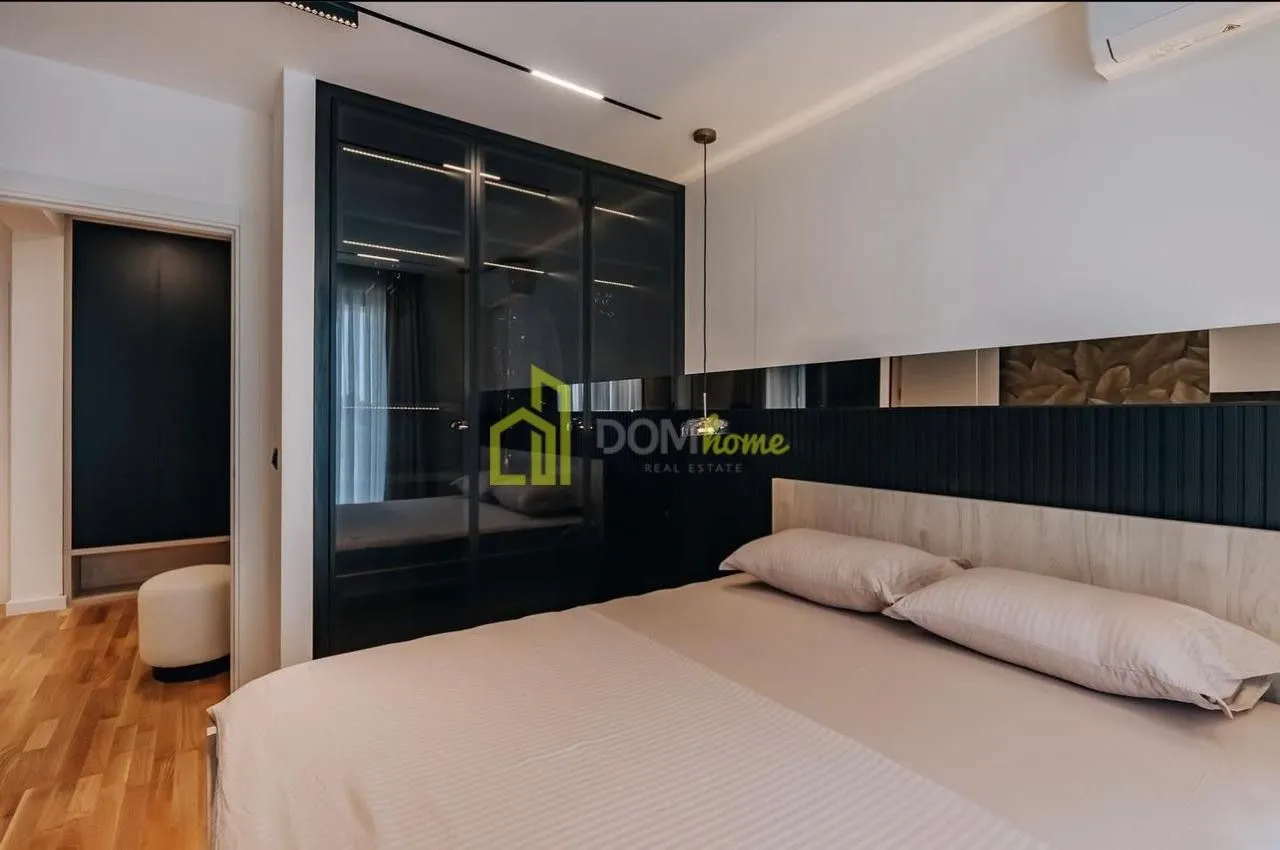 Modern bedroom with a large wardrobe and a double bed.
