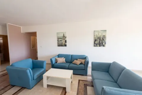 Spacious living room with a sofa set and a white coffee table. - image 2
