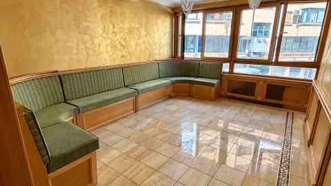 Living room with a large corner sofa and large windows. - image 4