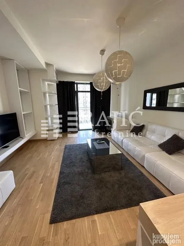 Living room with sofa, coffee table and TV unit.