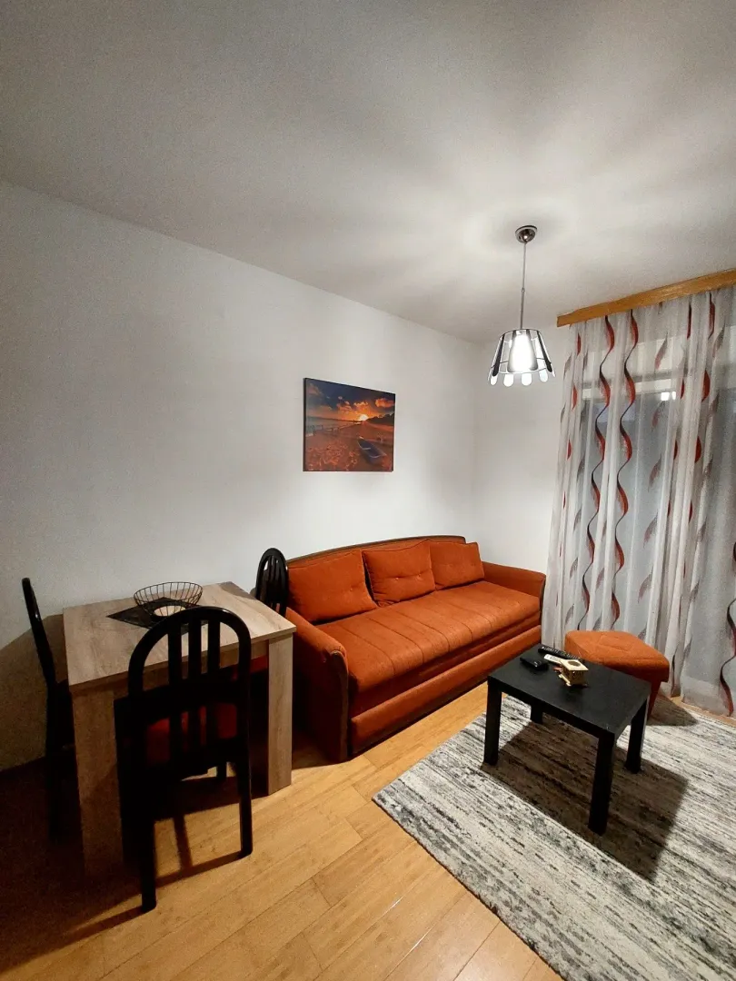 Living room with a sofa, dining table, and coffee table.