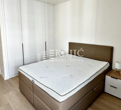 Bedroom with a double bed and built-in wardrobe. - image 10