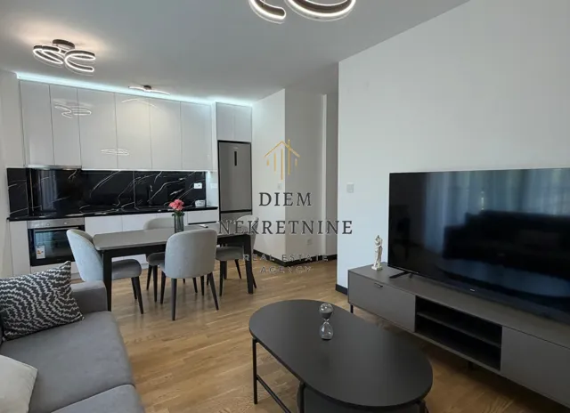 Modern living room with dining area and kitchen.