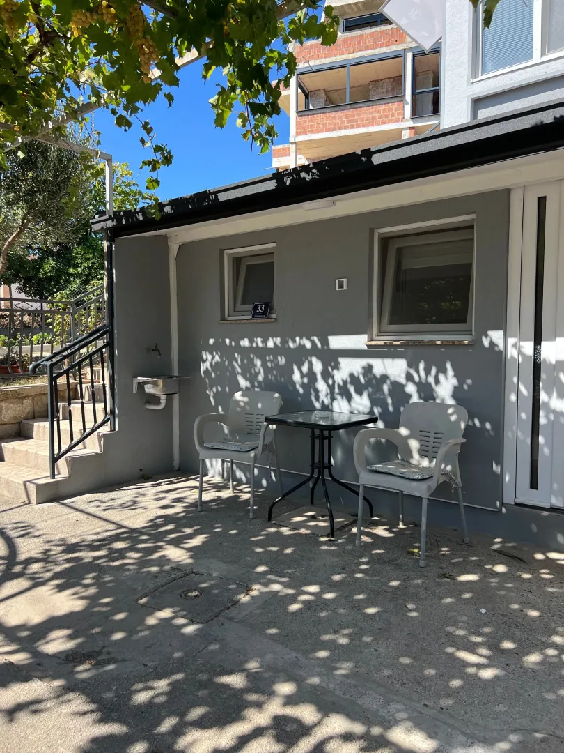 Yard with outdoor seating in front of the house.