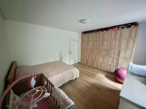 Bedroom with a bed, crib, and a large fitted wardrobe. - image 11