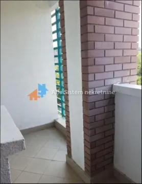 View of a spacious balcony with a brick-clad pillar and tiled flooring. - image 12
