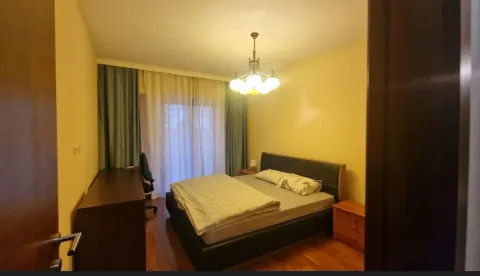 Simply furnished bedroom with a double bed and a desk. - image 10