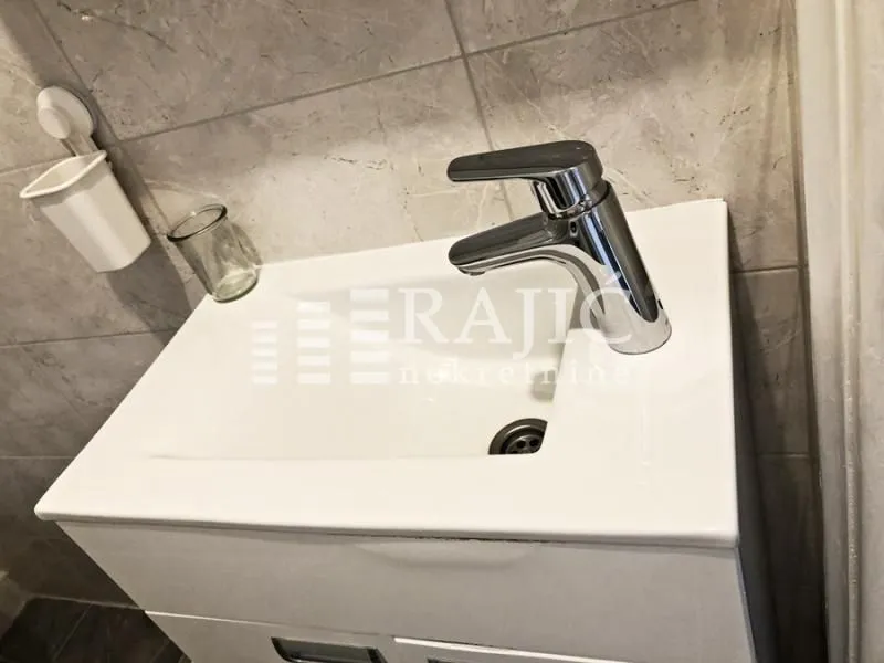 Close-up of a bathroom sink with a faucet.