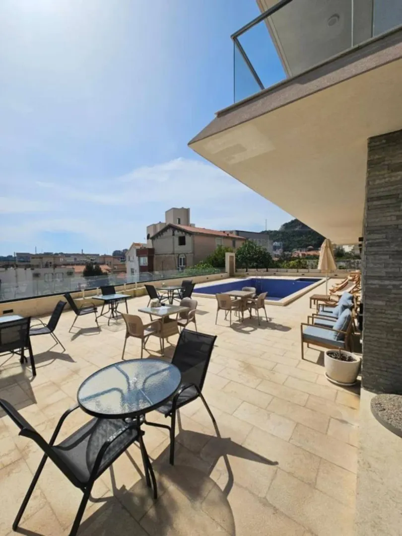 Large terrace with outdoor seating sets and a swimming pool.