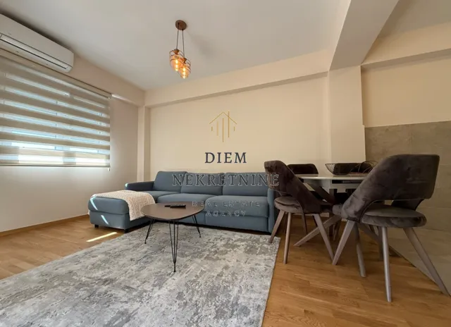 Living room with a sofa and dining table.