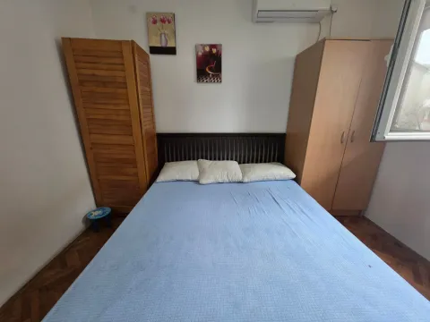 Furnished bedroom with a double bed, wooden wardrobes, and wall art. - image 18
