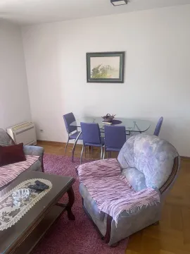 Bright living room featuring a dining table, armchair, and coffee table. - image 3