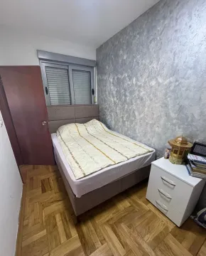 Small bedroom with a double bed, parquet flooring, and a decorative wall. - image 4