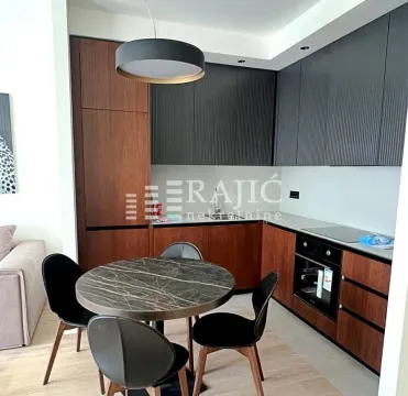Modern kitchen with a dining table and chairs. - image 5