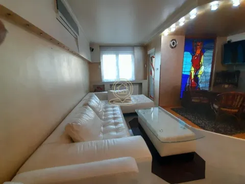 Living room with a white sectional sofa and a coffee table. - image 2