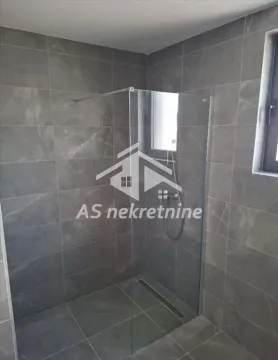 Modern tiles and a walk-in shower with a glass partition in the bathroom. - image 23
