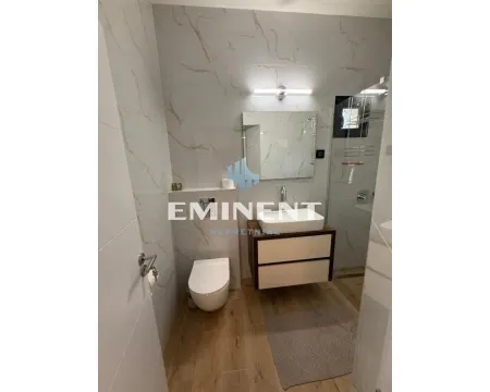 Modernly equipped bathroom with a washbasin, toilet, and walk-in shower. - image 15