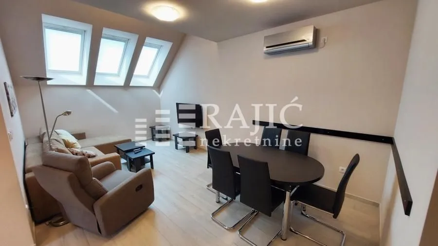 Spacious living room with dining area and skylights in the attic.
