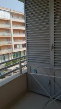 A balcony with a clothes drying rack and a view of the neighboring building. - image 14