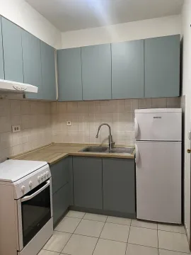 A small kitchen with grey-blue cabinets. - image 14