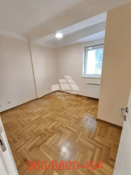 Empty room with wooden parquet flooring and a window. - image 5