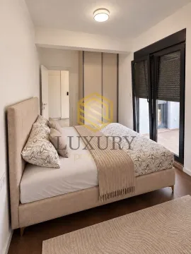 Bright bedroom with a double bed, built-in wardrobe, and access to the terrace. - image 2