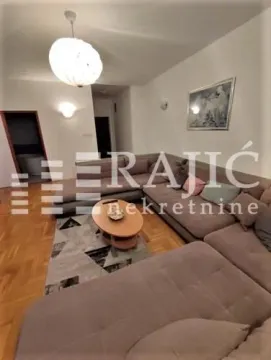Spacious living room with a sectional sofa and parquet flooring. - image 5
