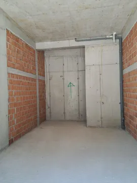 Unfinished space under construction with concrete and brick walls. - image 4