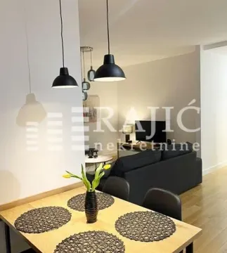 Living room with dining area and modern lighting. - image 5