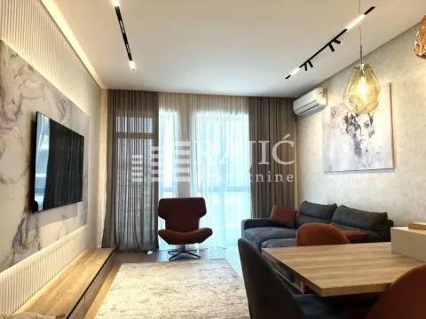 Modern and bright living room with a sofa and dining area. - image 2
