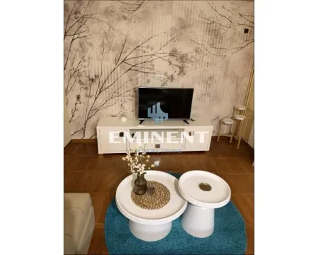 Living room with furniture, TV unit and decorative wallpaper on the wall. - image 2