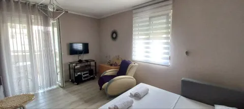 Furnished bedroom with a bed, armchair, and access to the terrace. - image 10