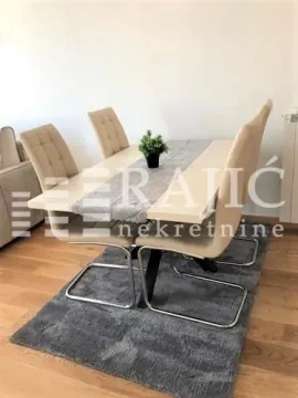 Dining area with a table and four chairs. - image 3