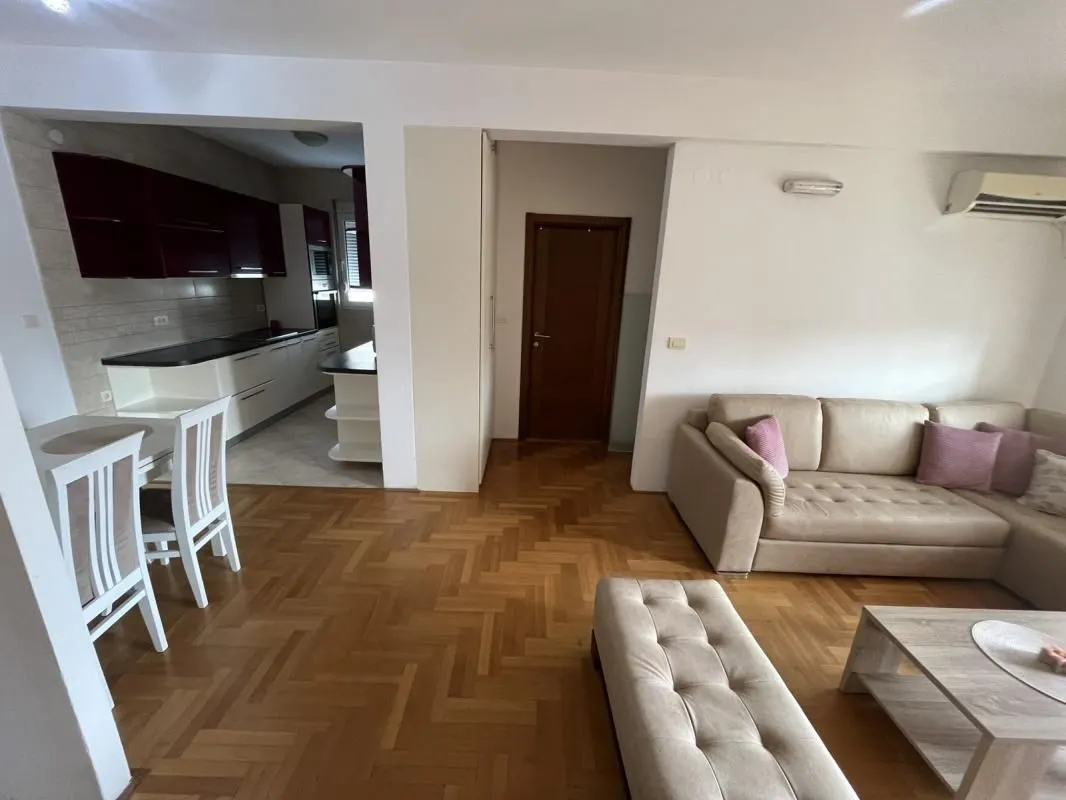 Living room with a sofa set and a dining area beyond.