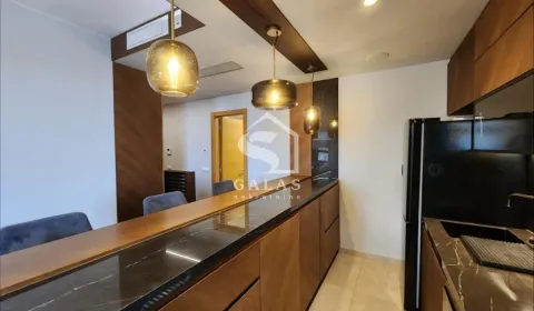 Modernly equipped kitchen with a bar and built-in appliances. - image 2