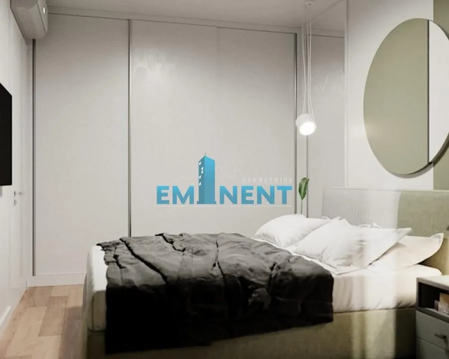 Modern bedroom with a double bed and a built-in wardrobe.