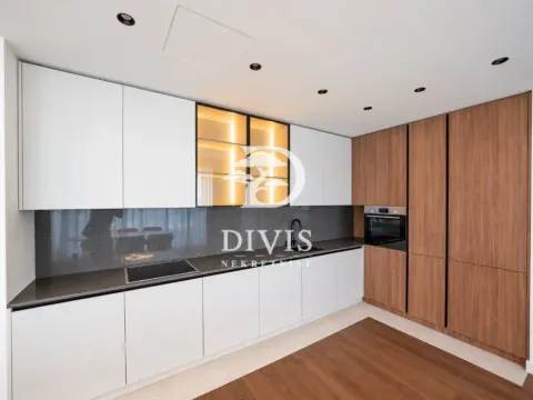 Modern kitchen with white cabinets, wooden fronts, and a built-in oven. - image 5