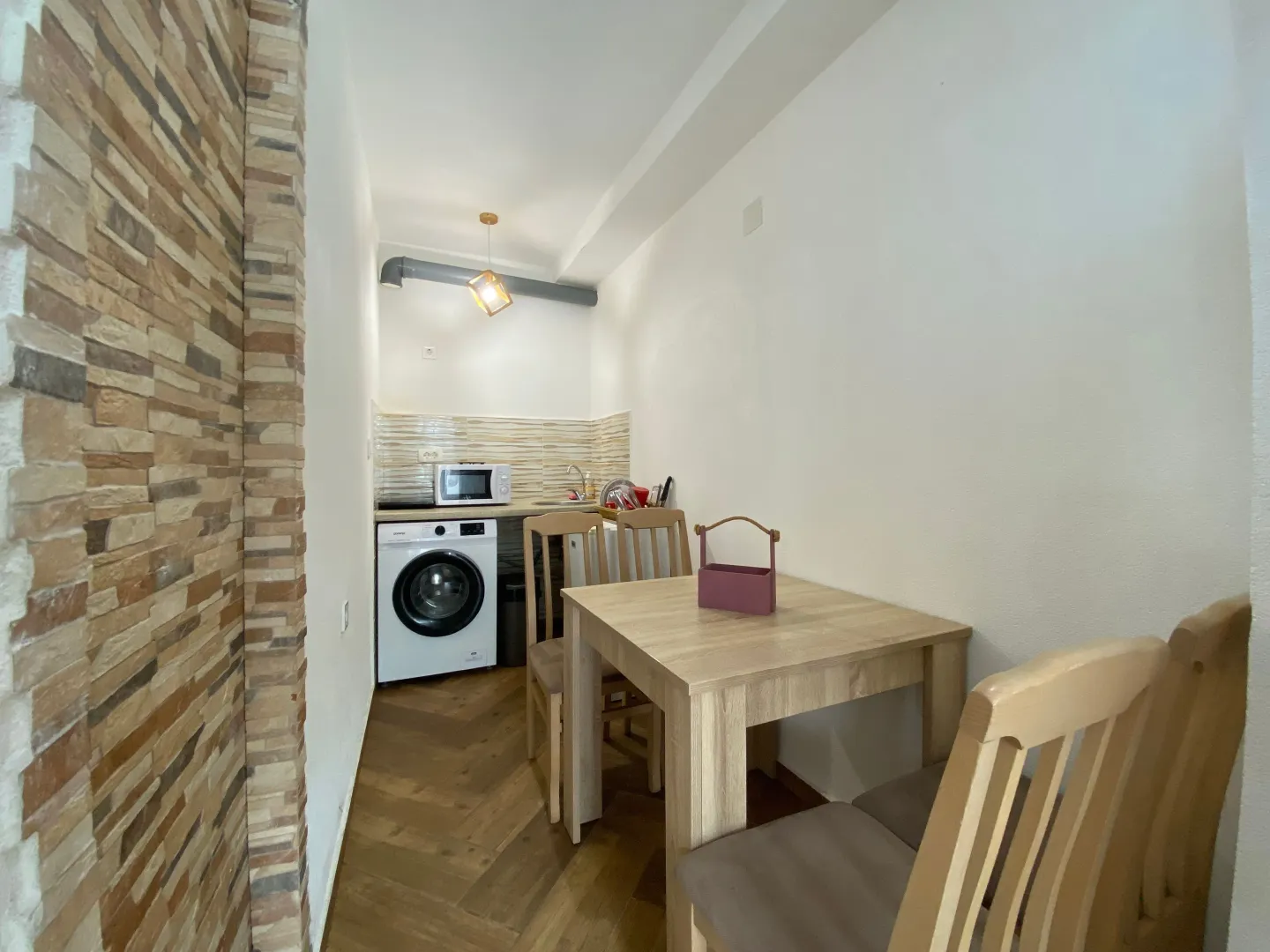 Small kitchen with a dining table and chairs.