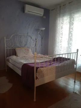 Bright bedroom with a white metal bed. - image 9