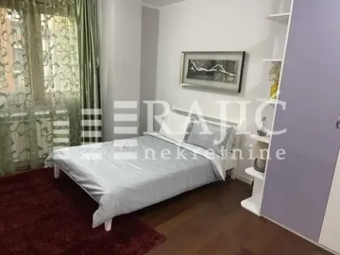 Furnished bedroom with a double bed, wardrobe, and window with curtains. - image 9