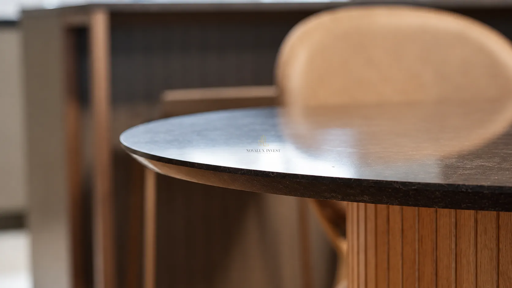 Circular wooden table with a chair in the interior.