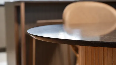 Circular wooden table with a chair in the interior. - image 8