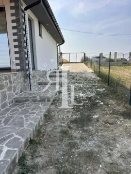 View of the exterior part of the house with stone paving and yard. - image 18