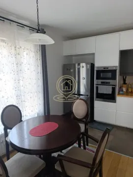 Kitchen with a dining area and built-in appliances. - image 11