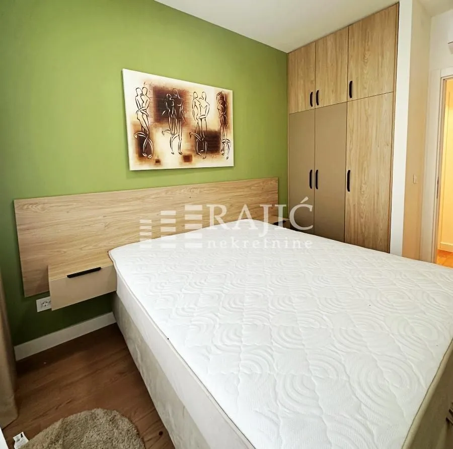 Furnished bedroom with a double bed and built-in wardrobe.