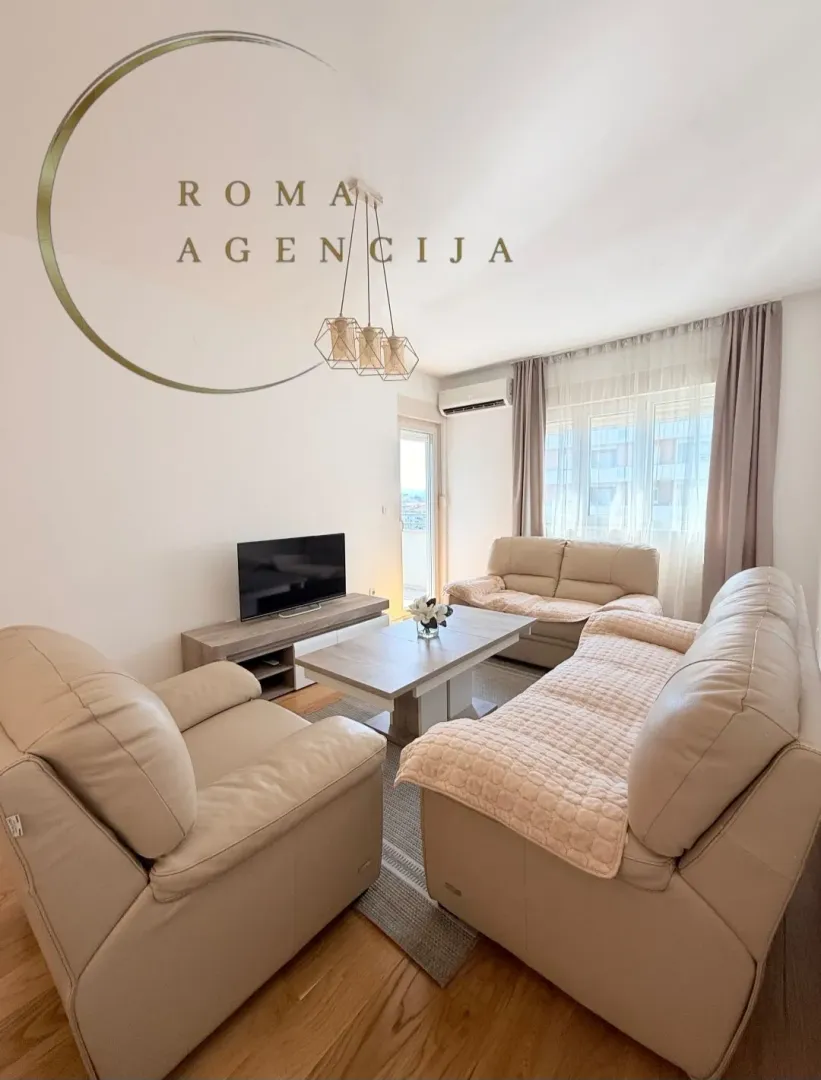 Bright living room with seating set and TV cabinet.