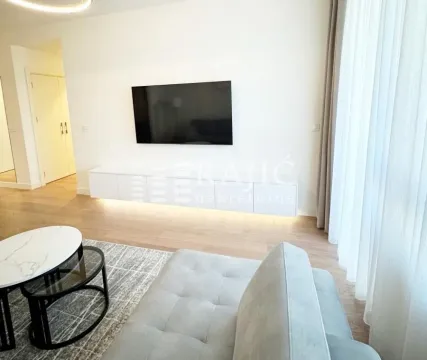 Modern living room with a sofa and TV. - image 2